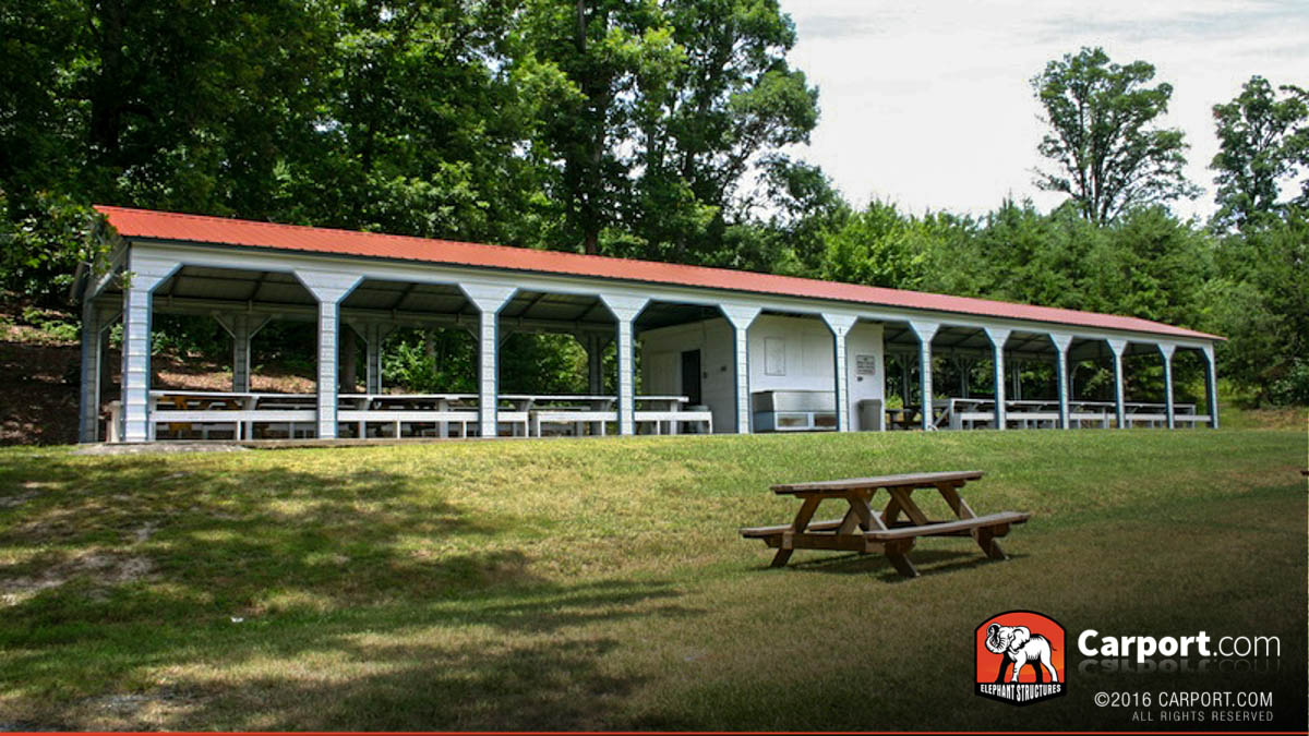 11-Bay-Metal-Picnic-Shelter-Carport-Pavilion- Eleven bay metal picnic shelter pavilion with picnic tables inside.