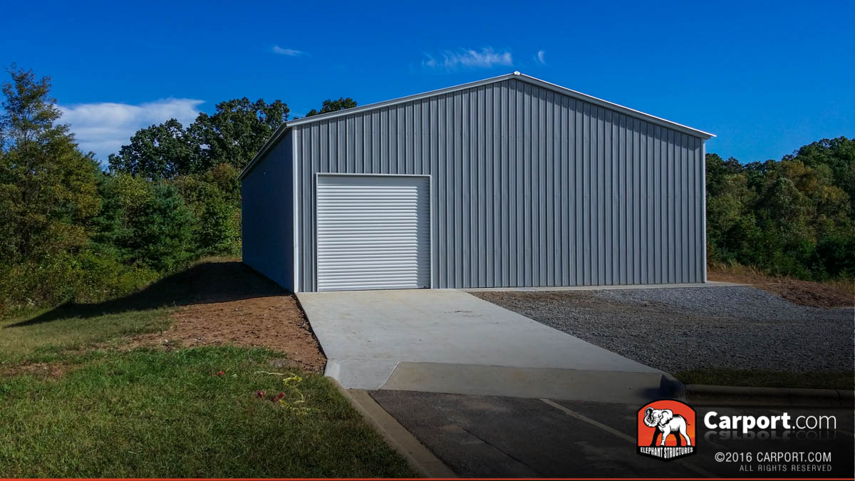 Commercial metal garage building with one roll-up garage door on the side.