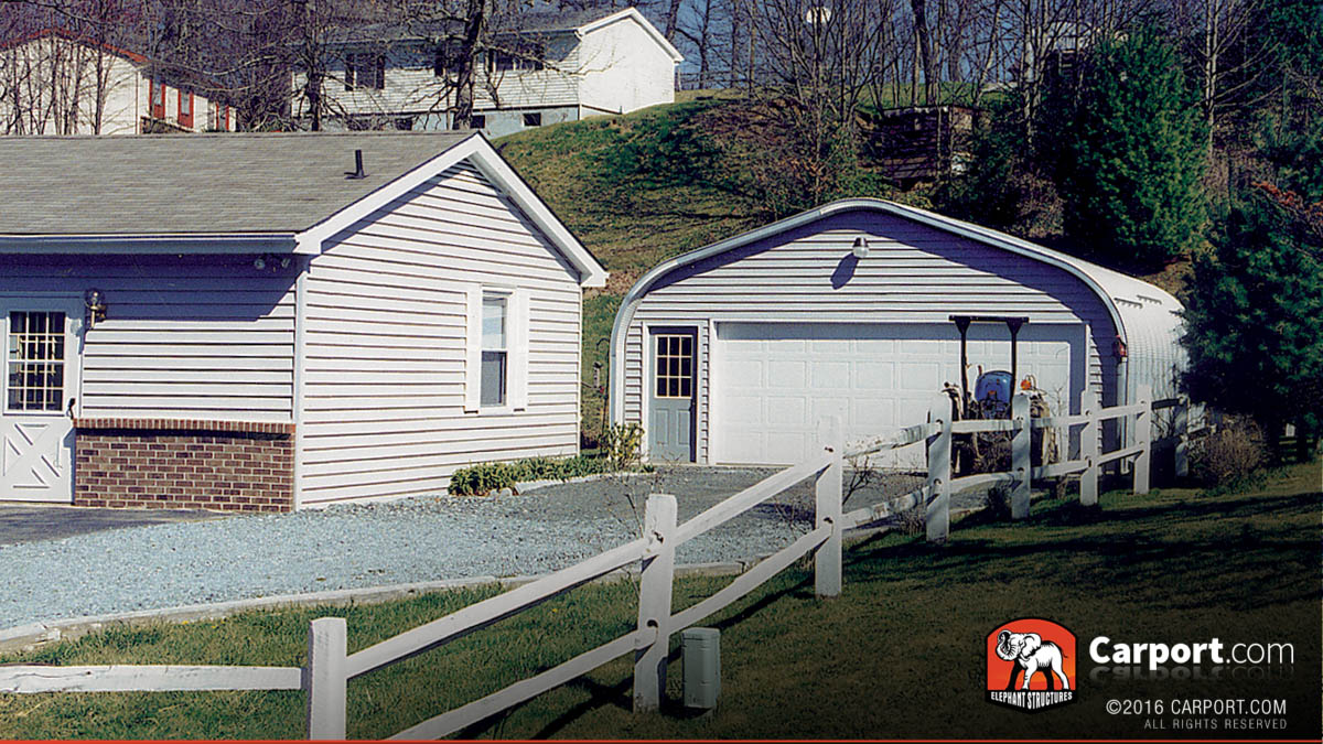 a-model-steel-arch-garage A model steel arch garage with one wide roll up door and a walk in door with grid windows.