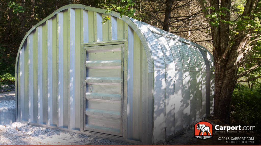 A model steel arch kit building with one swinging door.
