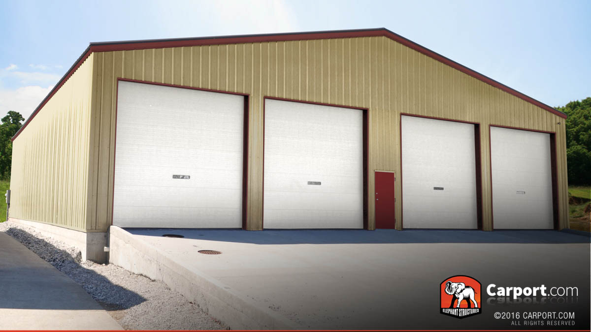 Commercial metal building with four roll up garage doors and one walk-in all on the front.