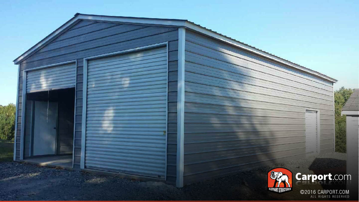 commerical-metal-buildings-21 Two car commercial metal building with two roll up doors on the front and one on the side.