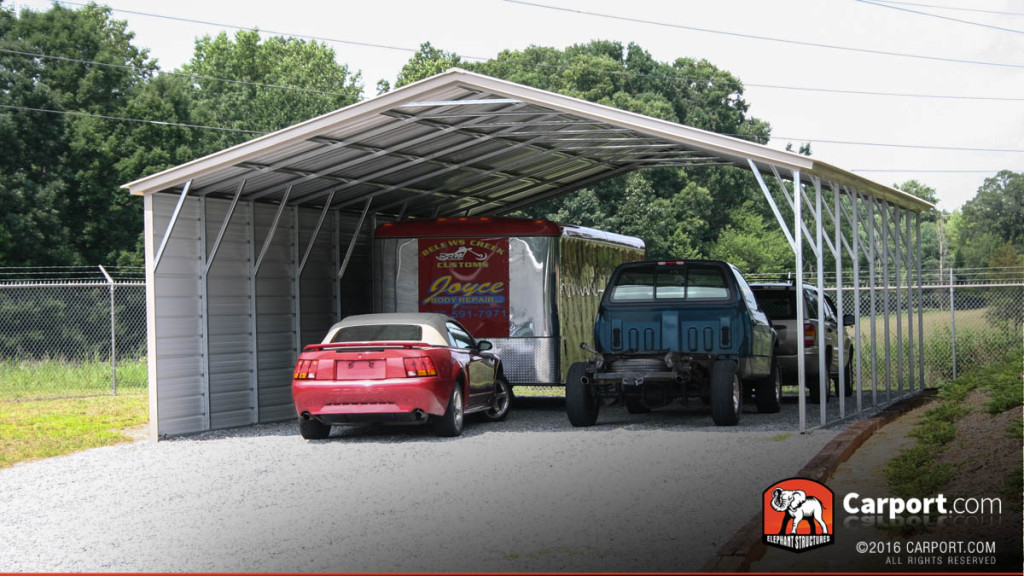 Four car carport with one side enclosed to protect from the elements.