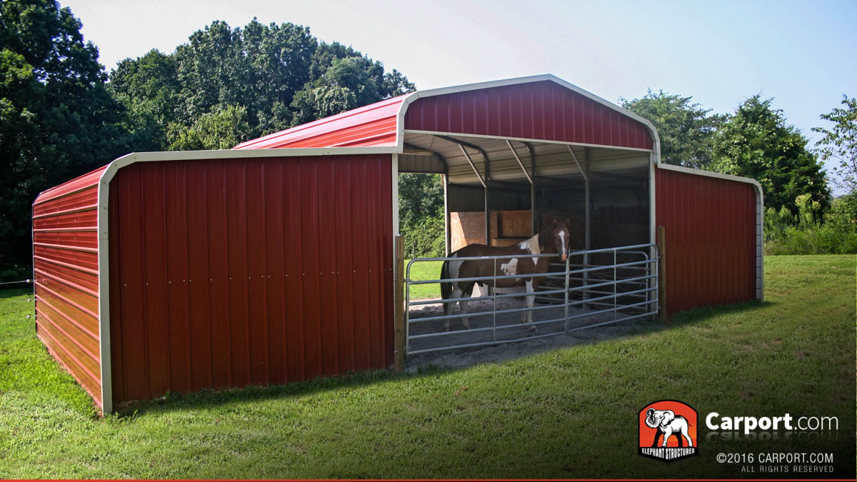 Country barn with enclosed lean-to's and gables on front and back of base structure.