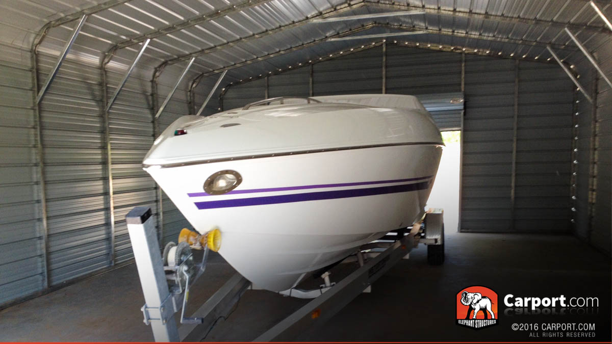 metal-garge-boat-storage-44401795 Metal boat cover carport with boat stored inside.